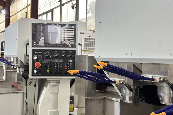 SYNTEC control panel beside multi-spindle heads with coolant lines