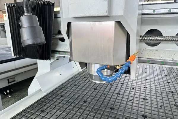 Spindle above the vacuum table holding a full sheet on an MNT CNC router