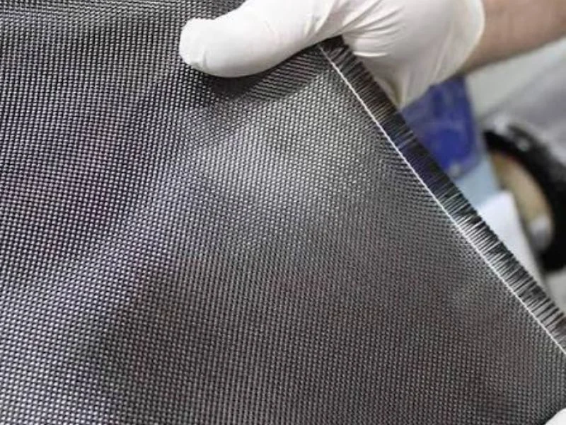 Five-axis CNC machine trimming a cured carbon fiber composite panel with a smooth, delamination-free edge