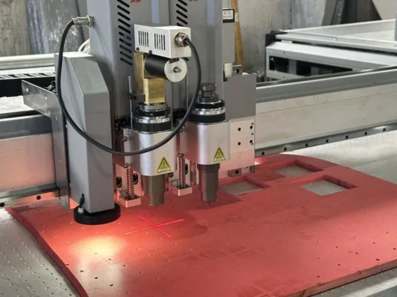 Close-up view of CNC router spindle and end mill tool for engraving solid wood and plastic sheets