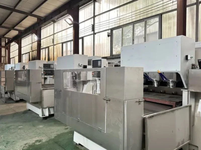 Fixed machine guard enclosure made of metal mesh and polycarbonate panels permanently attached to a CNC router to prevent operator contact with moving parts