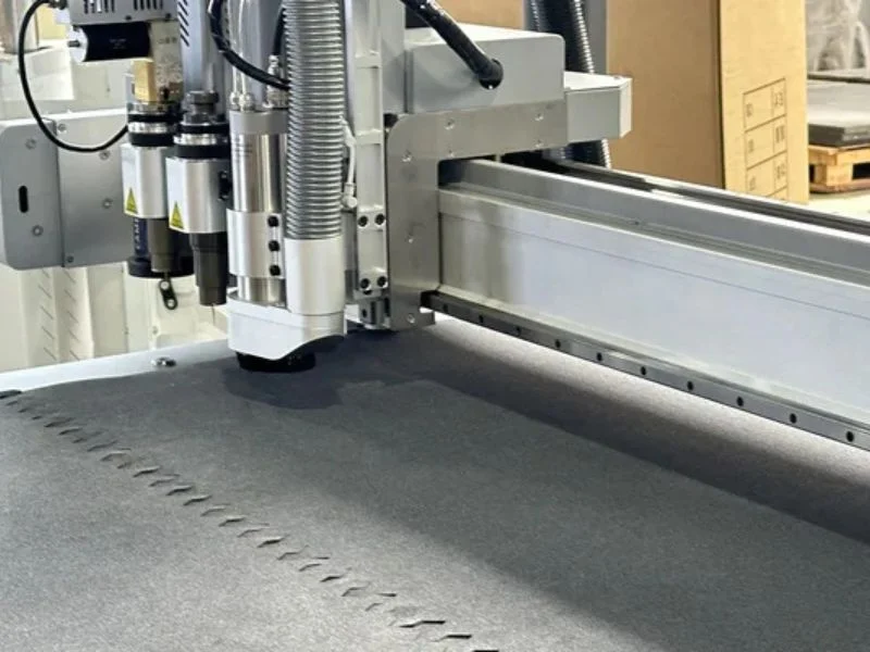 Independent vacuum zones on CNC flatbed cutting table for simultaneous processing of mixed rigid and flexible materials, ensuring optimal suction hold-down for each material type.