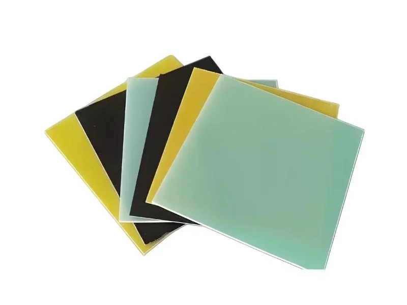 Stack of yellow-green G10 and FR-4 epoxy glass laminate sheets showing layered edges