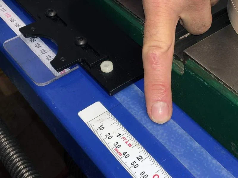 Long UHMW liner being measured against a steel rule at a stated temperature