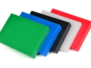 Black, green and natural UHMW-PE sheet stock stacked before machining