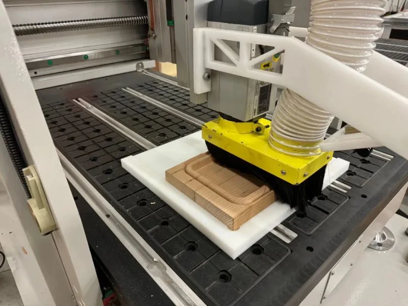 Full-area vacuum hold-down supporting a large UHMW sheet during machining