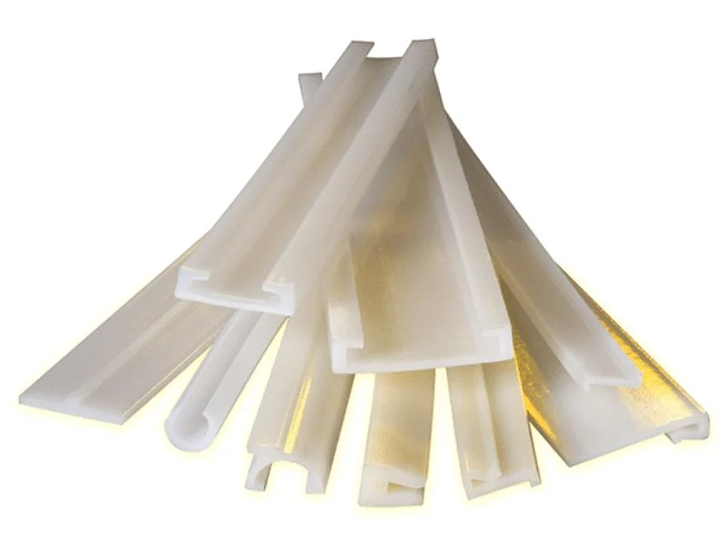 Machined UHMW wear strips and slide plates for conveyor systems