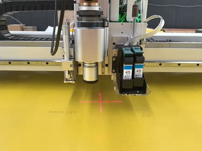 Wide zone-vacuum table holding a large coated tarpaulin roll flat on the MNT C3232