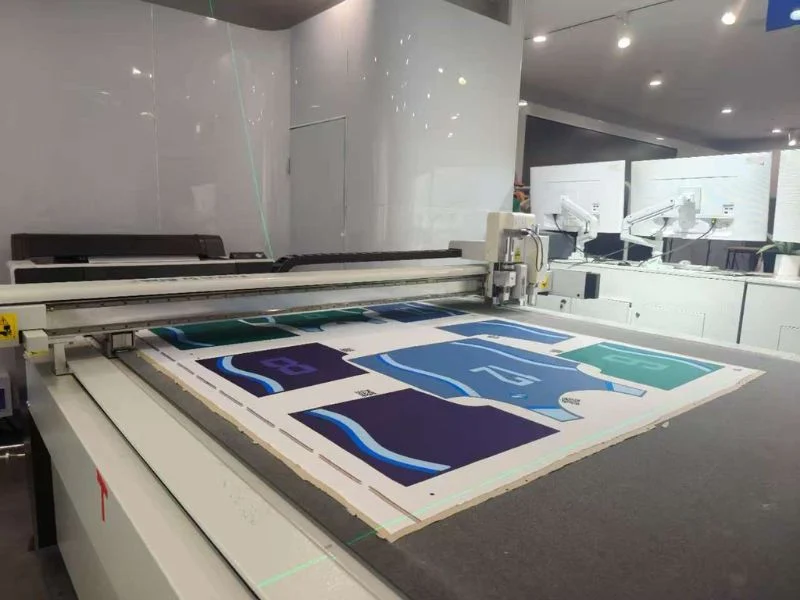 Roller feeder drawing fabric from the roll onto the conveyor of the MNT single-ply cutting line