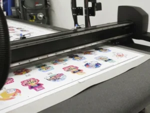 Flatbed cutter trimming printed graphics on a sheet
