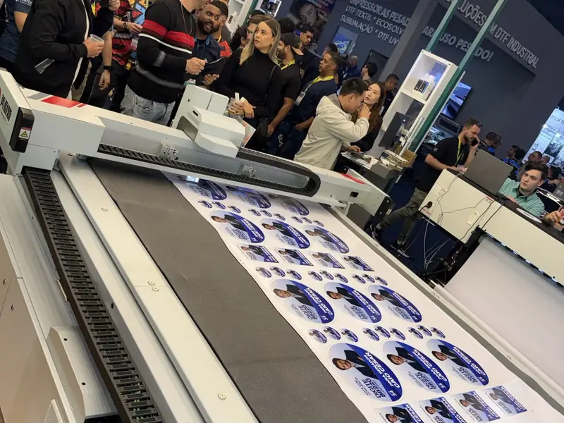 Printed label sheet on an MNT CR 2516T digital cutter at the Future Print 2026 booth